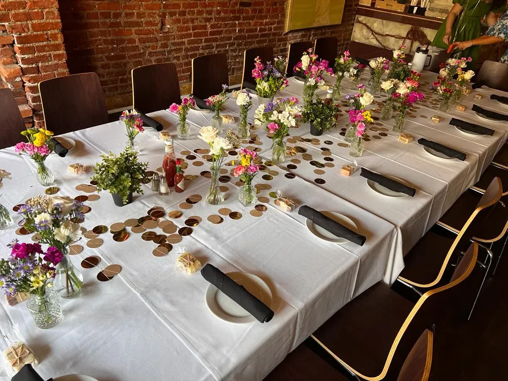 Guests gathered around a long table at a Mezè DC supper